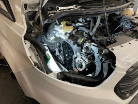 side of ford transit removed to reveal belt system